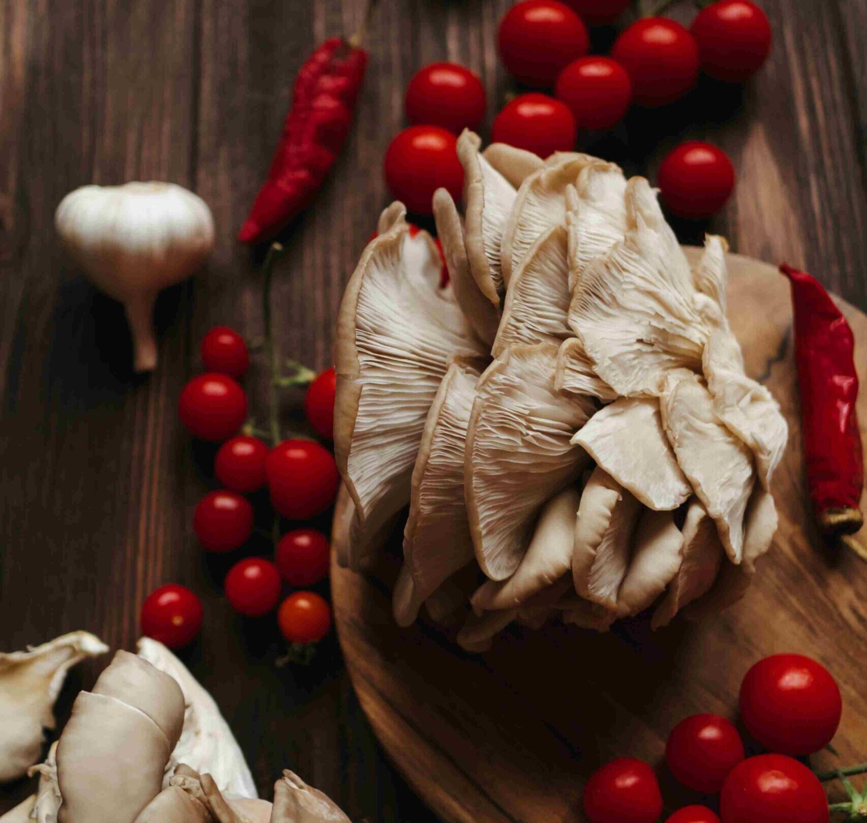 Hiratake Mushrooms on wood table with tomatoes